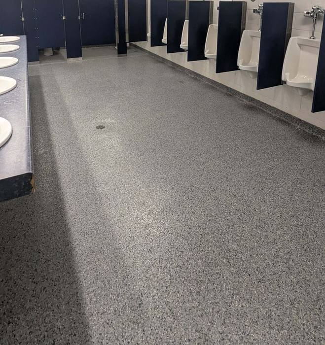 Commercial epoxy flake flooring installed in a restroom facility