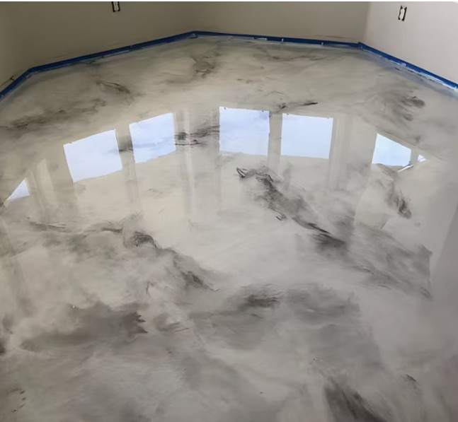 Professional installing marble epoxy flooring with careful technique